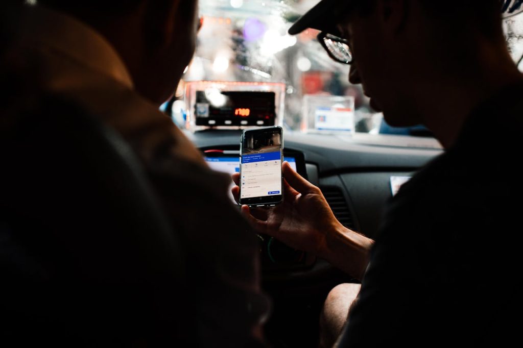 pexels-photo-7263902 A Person Holding a Mobile Phone Inside the Taxi
